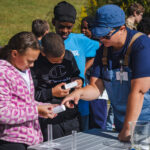Educator showing the students how to read a water quality test.