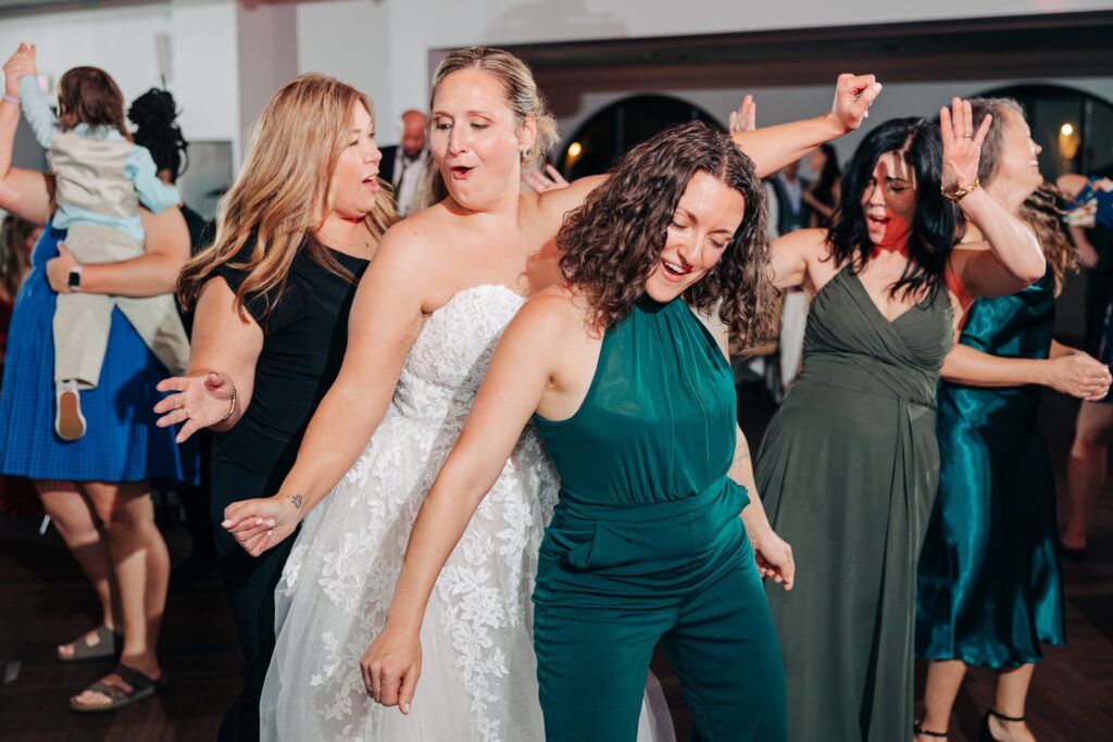 Bride dancing with guests on the dance floor.